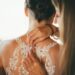 a woman in a wedding dress getting ready for her wedding